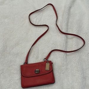 Small crossbody Coach purse/wallet in coral color.